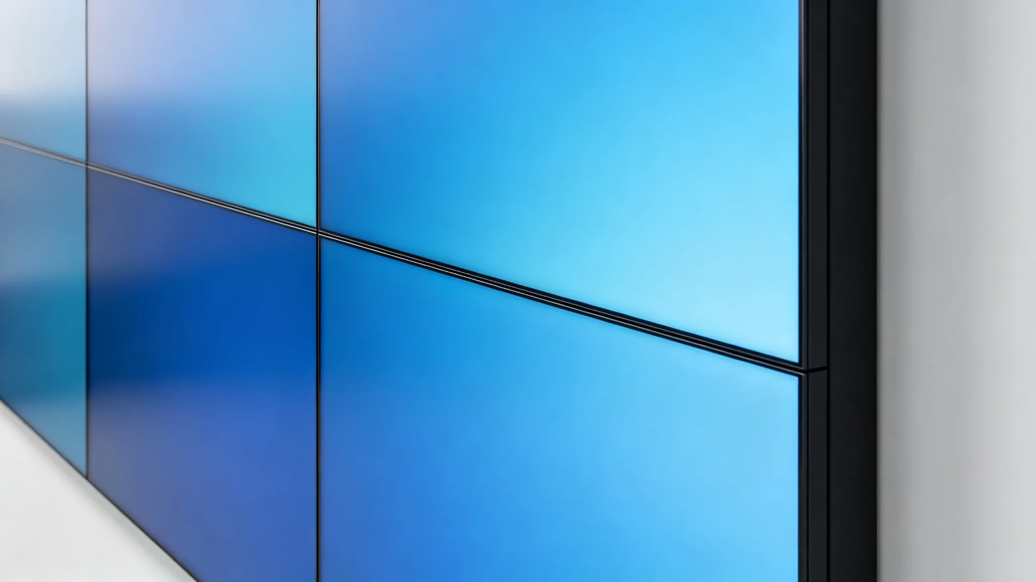 Narrow bezel LCD video wall panels joined with a nearly invisible seam and uniform color